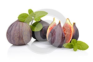 Three figs with mint,split like flower isolated on white backgro