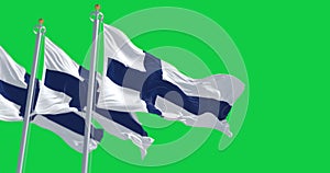 Three Finland national flags waving isolated on a green background