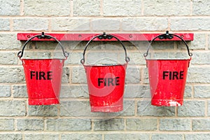 Three fire buckets hanging on a wall