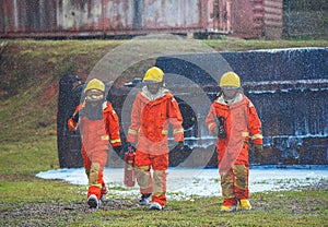 Three firefighters in uniform walking forward