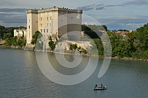 Three fishermen on river Rhone under castle Tarascon