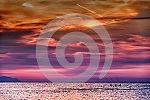 Three fishermen at sunset