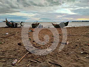 three fishing boats on the beach with the simplicity of the beach from Muaro Bayang