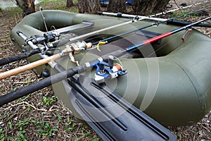 Three fishing spinning in a rubber boat