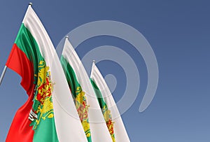 Three flags of Bulgaria on flagpole on blue background. Place for text. The flag is unfurling in wind. Bulgarian. Europe, Sofia.