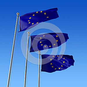 Three flags of Europe Union against blue sky.