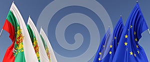 Three flags of European Union and Bulgaria on flagpoles on the sides. Flags on a blue background. Place for text. EU, Europe. Flag