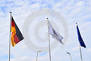 three flags, of the European Union, Germany and village Wellen
