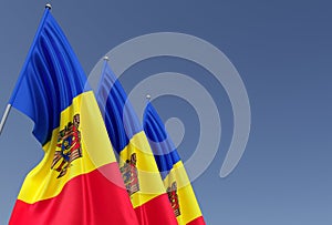 Three flags of Moldova on flagpole on blue background. Place for text. The flag is unfurling in wind. Chisinau. Europe, Moldavian