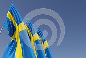 Three flags of Sweden on a flagpole on a blue background. Place for text. The flag is unfurling in wind. Swedish. Europe,