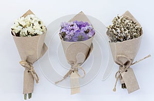 Three flower bouquet on white background.