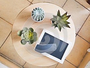 three flowers along with one photo frame on a corner table