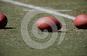 Footballs on a lined football field photo