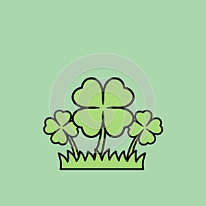 Three Four-Leaf Clovers Growing in a Patch of Grass