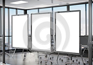 Three frames Mockup hanging on office glass window. Mock up of a billboards in modern company interior
