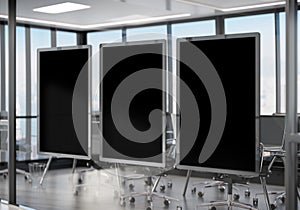 Three frames Mockup hanging on office glass window. Mock up of a billboards in modern company interior