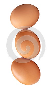 Three fresh brown chicken eggs in stack isolated on white background with clipping path