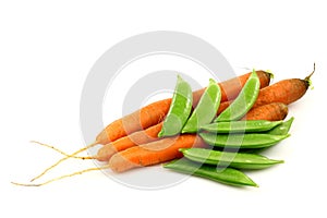 Three fresh carrots and some sugar snaps photo