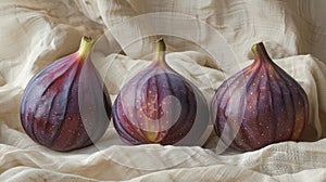 Three fresh figs on cloth.