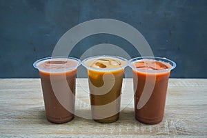 Three fresh iced chocolate drinks are placed on the tabl