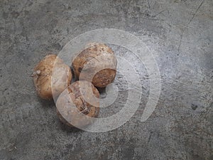 Three Fresh Jicama on a Rough Surface