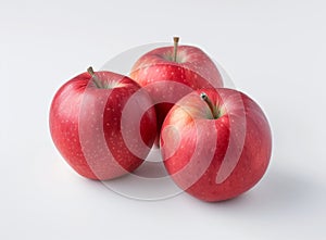 Three fresh, juicy, ripe, red apples isolated on a white background.