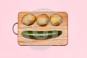 Three Fresh Potatoes Near Cucumber