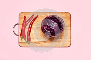 Three Fresh Red Chilli Pepper Near One Violet Cabbage