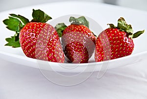 Three fresh red strawberries