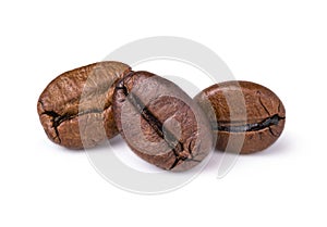 Three fresh roasted dark brown arabica coffee beans isolated on a white background with clipping path