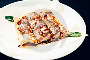 Fresh rolled stuffed crepes on plate