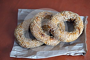 Three fresh tasty pretzels on paper from the bakery.