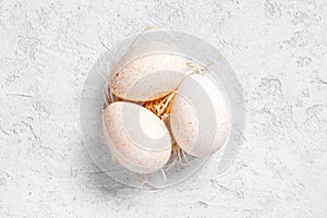 Three fresh turkey eggs on the white table