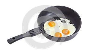 Three fried eggs on the frying pan during cooking