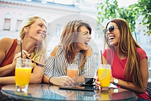 Three friends in a cafe having fun