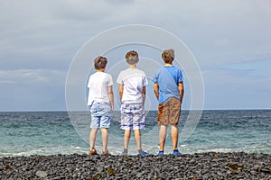 Three friends in front of the ocean in Lanzarote