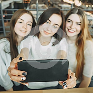 Three friends have fun together and take selfie
