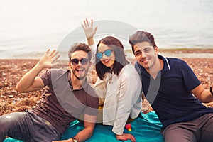 Three friends having fun at the beach, springtime