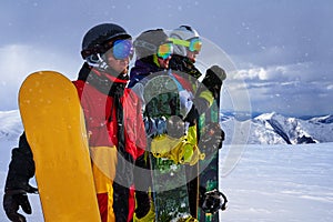 Three friends look forward snowboarders courageously