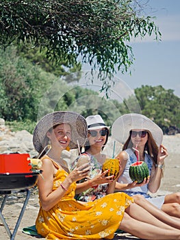 Three friends on a picnic near the sea