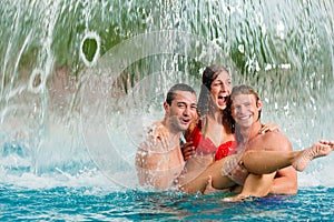 Three friends in public swimming pool