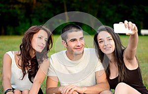 Three friends taking photos outside and smiling