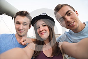 Three Friends Taking Selfie On The Bridge