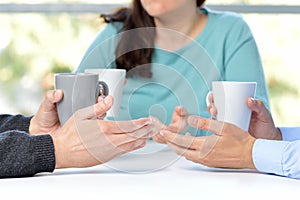 Three friends talking with coffee cups