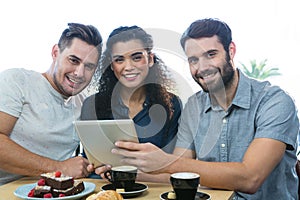 Three friends using a digital tablet