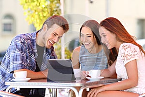 Three friends watching tv or social media in a tablet