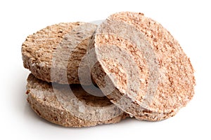 Three frozen hamburger patties on white.