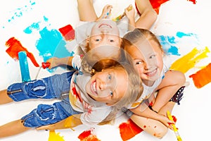 Three funny girls sitting on a floor