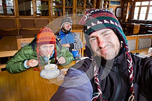 Three funny tourists nepali guesthouse dining room eating noodle photo