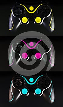 Three Gaming joysticks isolated on black background with buttons and Cyan, Magenta, Yellow, Key color